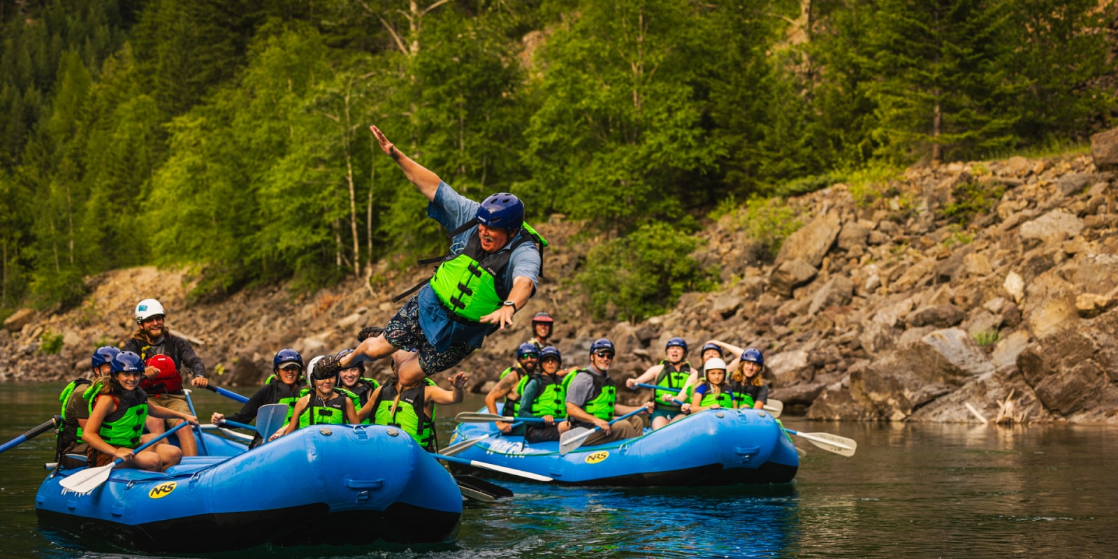 Man jumping into water on Whitewater Rafting Montana trip with Wild River