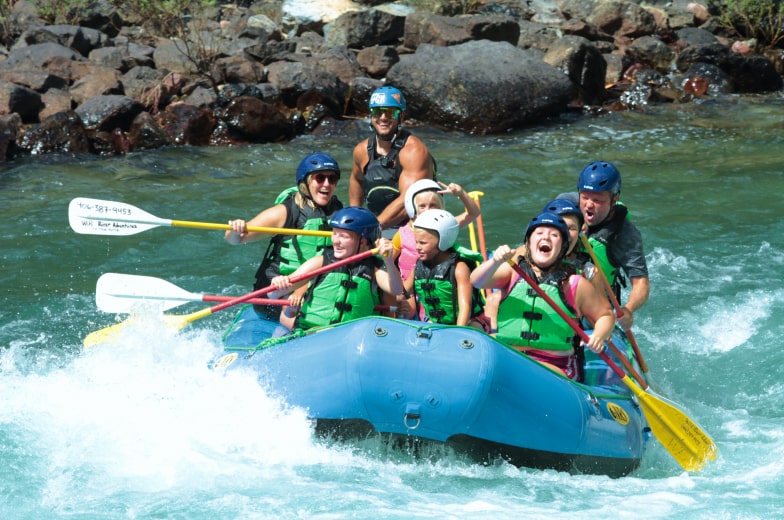 Smiling family on a whitewater rafting trip with Wild River