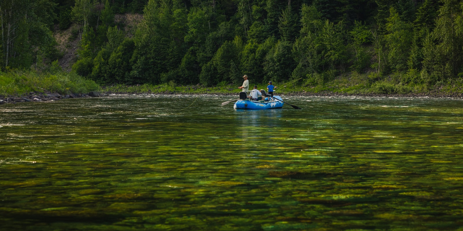 Group of men fly fishing on the Flathead River with Wild River