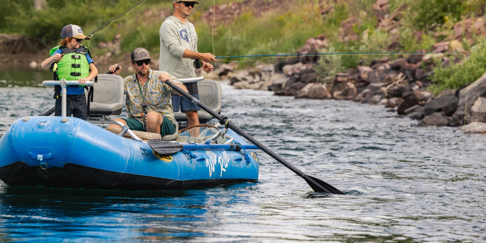 Young boy and dad fly fishing with Wild River