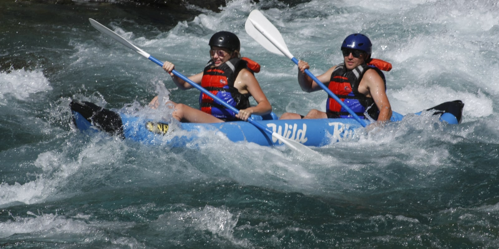Couple enjoying an inflatable kayak trip near Glacier with Wild River